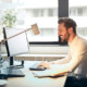 A smiling man working at a computer